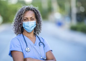 African American medical professional Portrait of an African American nurse wearing a protective face mask to avoid the transfer of germs during the COVID-19 outbreak.